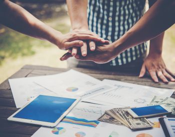 Business people making pile of hands. Teamwork concept.