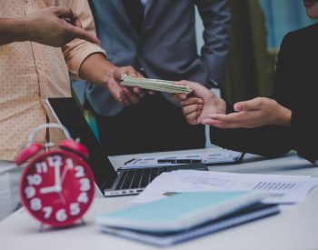 Business partners discussing documents and ideas at meeting. Benefit-sharing, Business success.